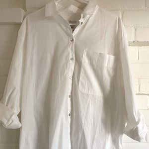 White Button down collard shirt with iridescent buttons.